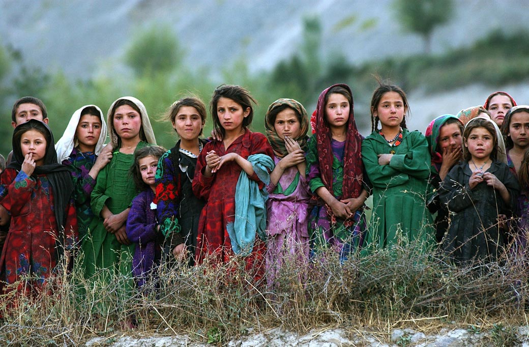 kabul girls photos. Local girls look at a U.N.