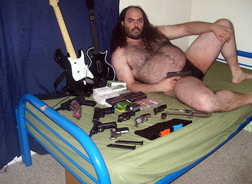 [Image: fat_hairy_guy_on_bed_with_guns.jpg]